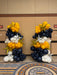 Decorative balloon arrangement in navy, yellow, and white on a wall.